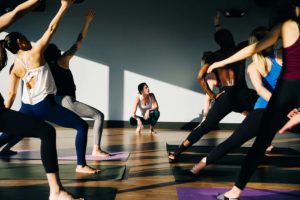 Yoga and fitness brands building community outside of social media like this picture of a yoga class and instructor. 